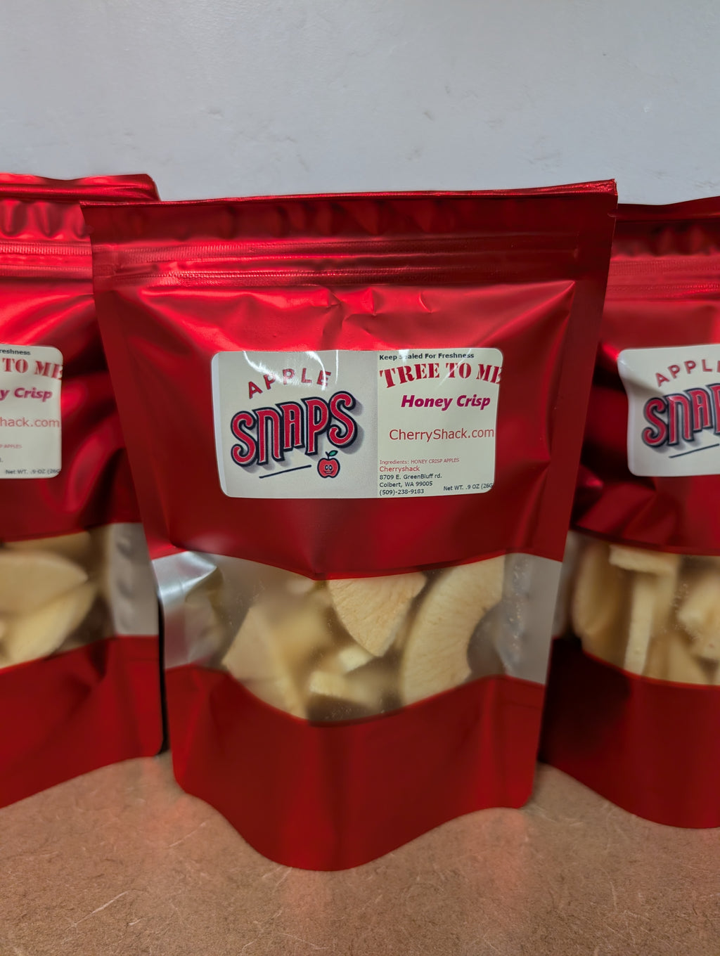Freeze Dried Green Bluff Honey Crisp Apples in a red bag. Apple Snaps